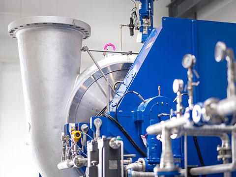 Turbo compressors with integrated gearboxes