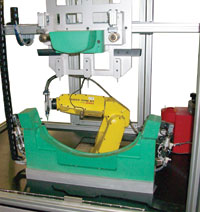 Robot gluing cell produces parts for robotic lawn mower